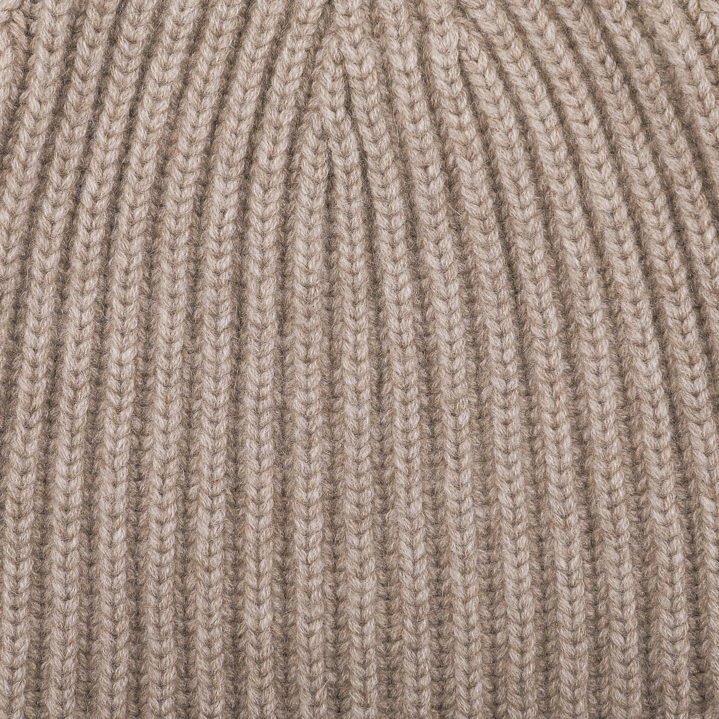 Close-up view of the Stoneage Beige Cashmere Ribbed Short Beanie by William Lockie, showcasing the intricate knitted fabric with its chunky cashmere thread pattern.