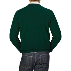 A person is shown from the back wearing a Tartan Green Crew Neck Lambswool Sweater by William Lockie and blue jeans.