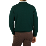 The back view of a man wearing a Tartan Green Crew Neck Lambswool Sweater by William Lockie and brown pants.