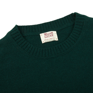 A William Lockie Tartan Green Crew Neck Lambswool Sweater with a label on it.