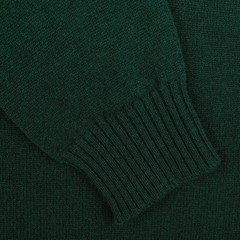 Close-up of the Tartan Green Crew Neck Lambswool Sweater sleeve showing the ribbed cuff and texture of the fabric, made from luxurious Scottish lambswool by William Lockie for extra warmth.