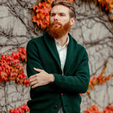 A bearded man wearing a Tartan Green Lambswool Shawl Collar Cardigan by William Lockie.