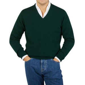 A man donning a William Lockie Tartan Green Lambswool V-Neck Sweater.