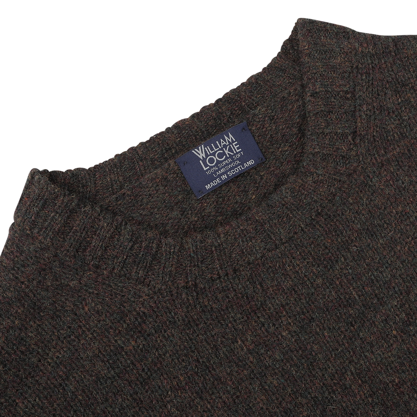 Close-up of a William Lockie Turin Brushed Shetland Lambswool Crew Neck sweater in brown, featuring a label that reads "Made in Scotland," showcasing exquisite lambswool knitwear craftsmanship.