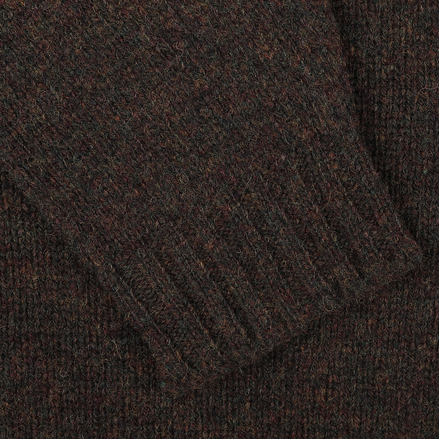 A close-up of a dark brown Turin Brushed Shetland Lambswool Crew Neck highlights its ribbed cuffs, echoing the classic style of a William Lockie sweater.