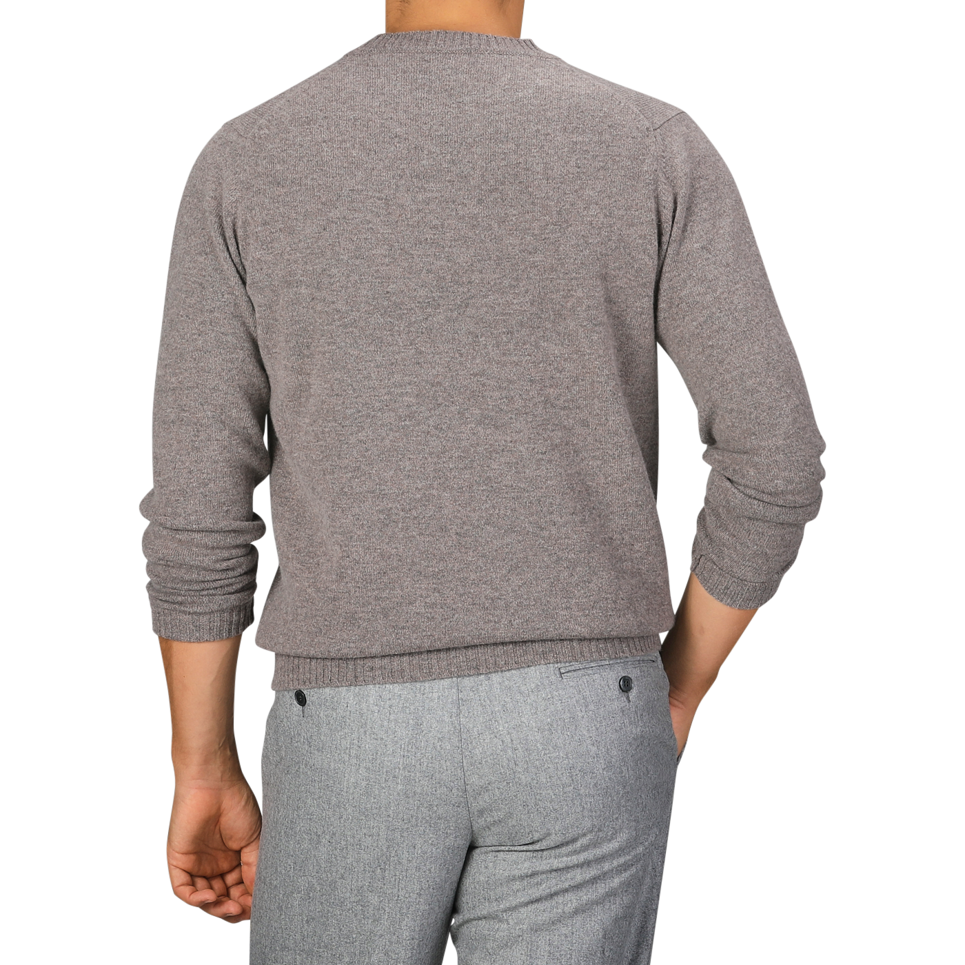 A person wearing a beige Scottish lambswool sweater and grey pants is photographed from behind. The William Lockie Vole Beige Crew Neck Lambswool Sweater features long sleeves and a crew neck.