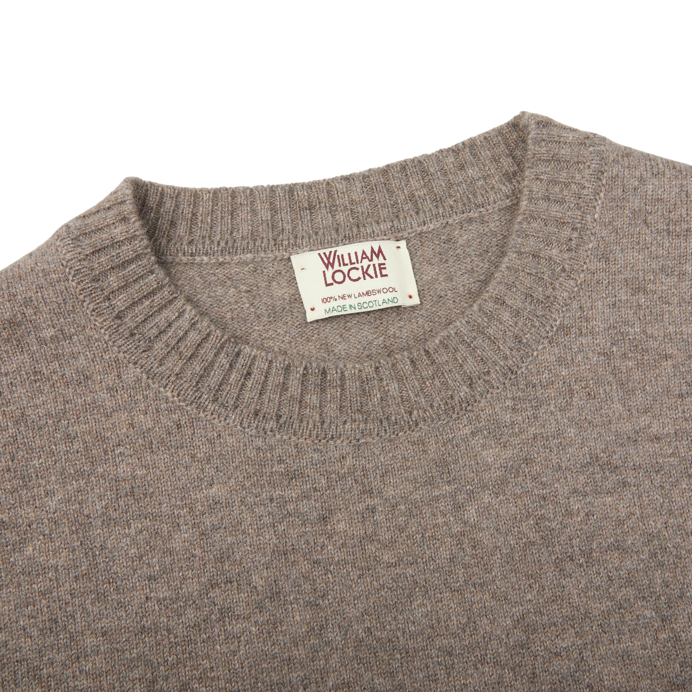 A comfy William Lockie Vole Beige Crew Neck Lambswool Sweater with a label on it.