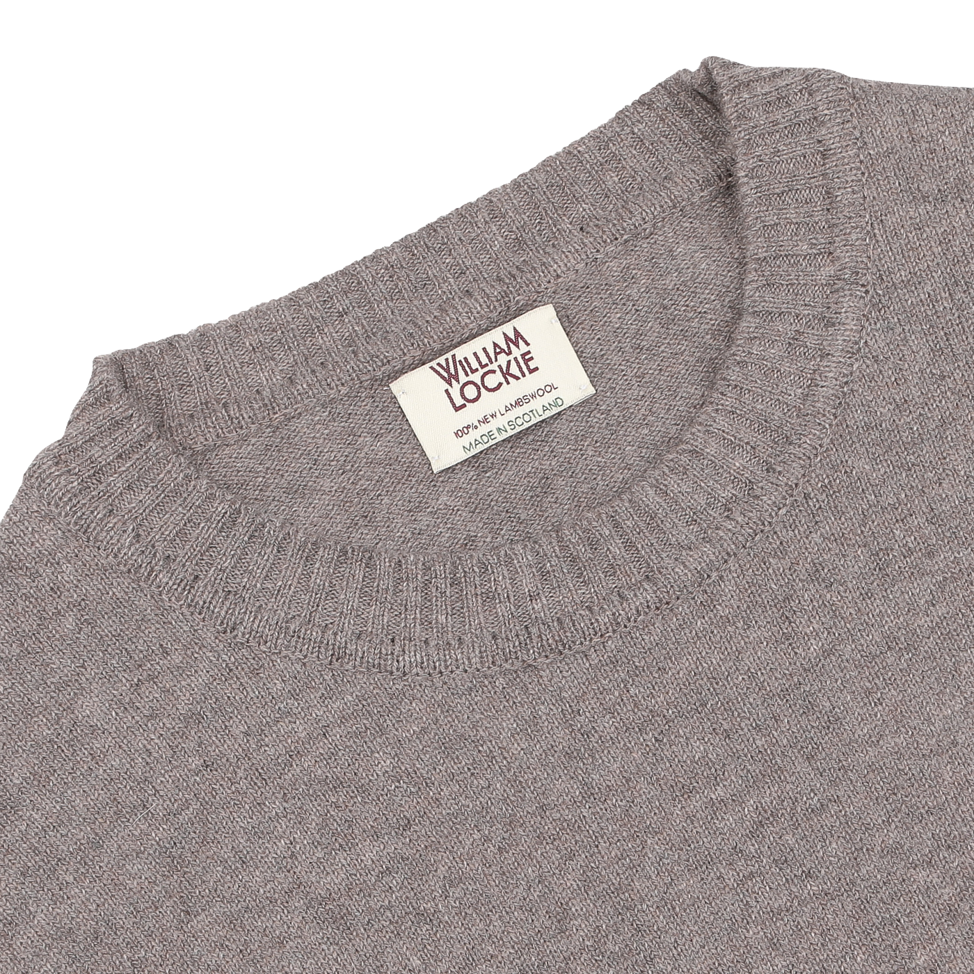 Close-up of the Vole Beige Crew Neck Lambswool Sweater with a label reading "William Lockie, Made in Scotland." The Scottish lambswool sweater features a ribbed neckline.