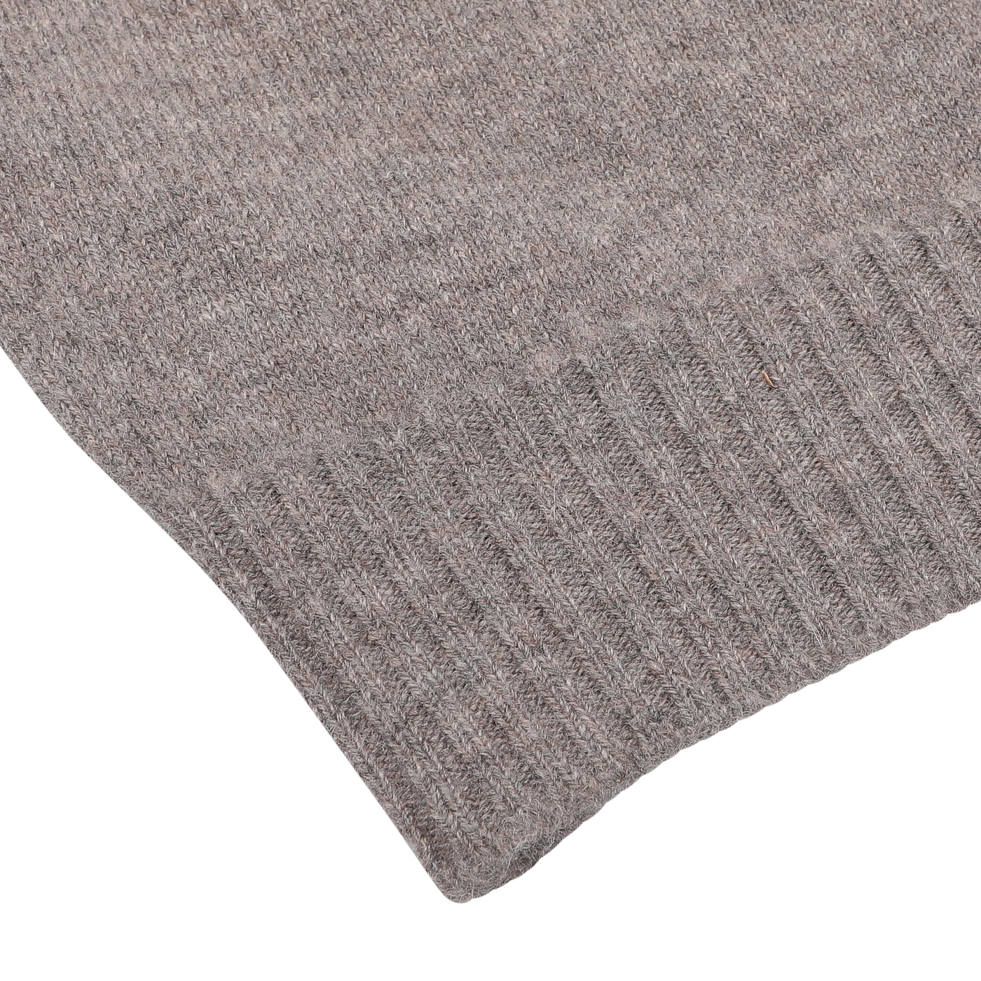 Close-up of a grey knitted fabric, showing the textured stitching and edge detailing. The material appears soft and cozy, reminiscent of a William Lockie Vole Beige Crew Neck Lambswool Sweater made from fine Scottish lambswool.