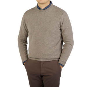 A man wearing a Vole Beige Crew Neck Lambswool Sweater by William Lockie.
