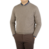 A man wearing a Vole Beige Crew Neck Lambswool Sweater by William Lockie.