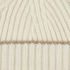 A close up image of a William Lockie White Undyed Cashmere Ribbed Short Beanie.