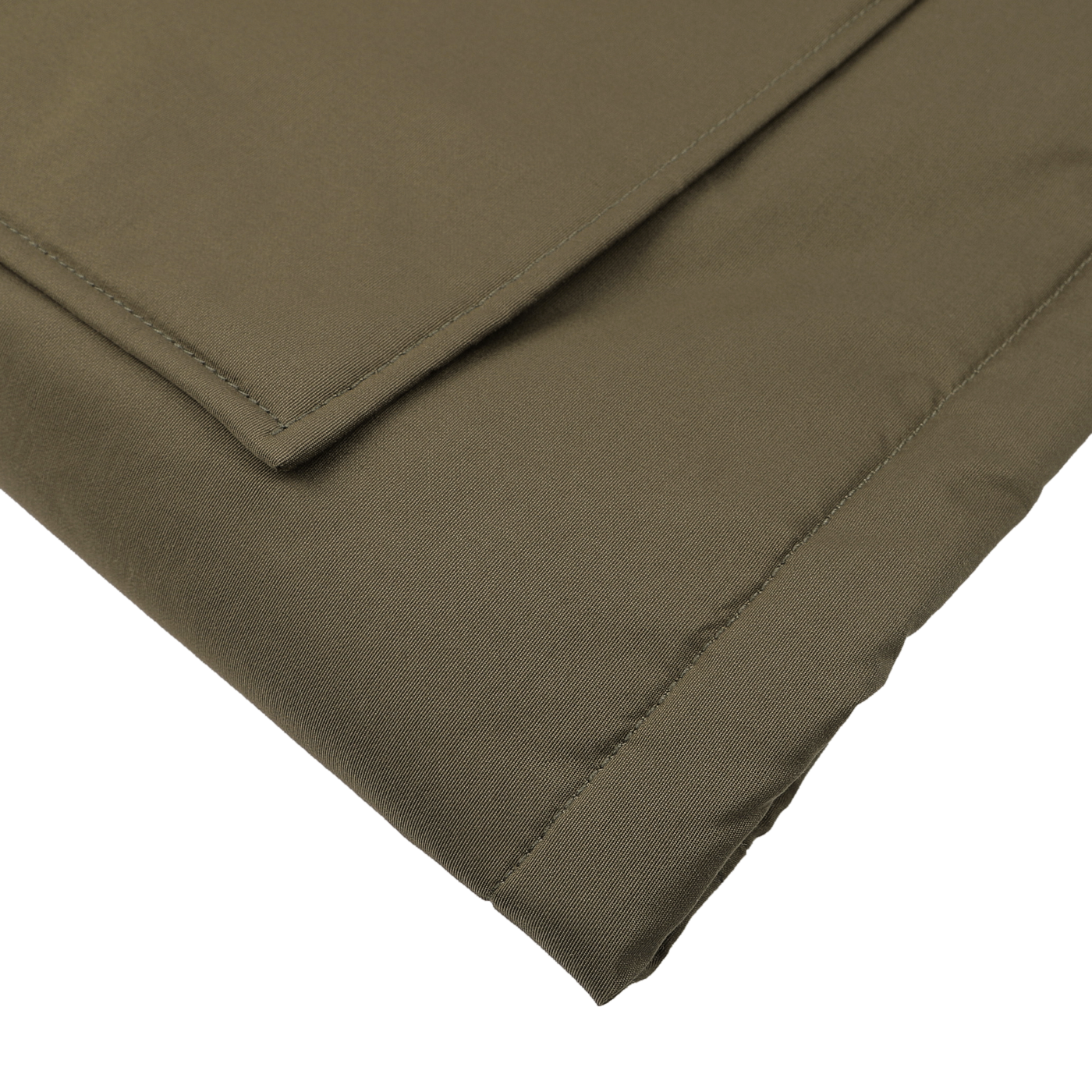 Close-up of a folded dark green fabric, likely part of a Woolrich garment or textile, with visible stitching and neat edges. This could be from the Dark Green Stretch Nylon Arctic Parka, designed for extreme conditions and featuring waterproof properties to provide enhanced protection against the elements.