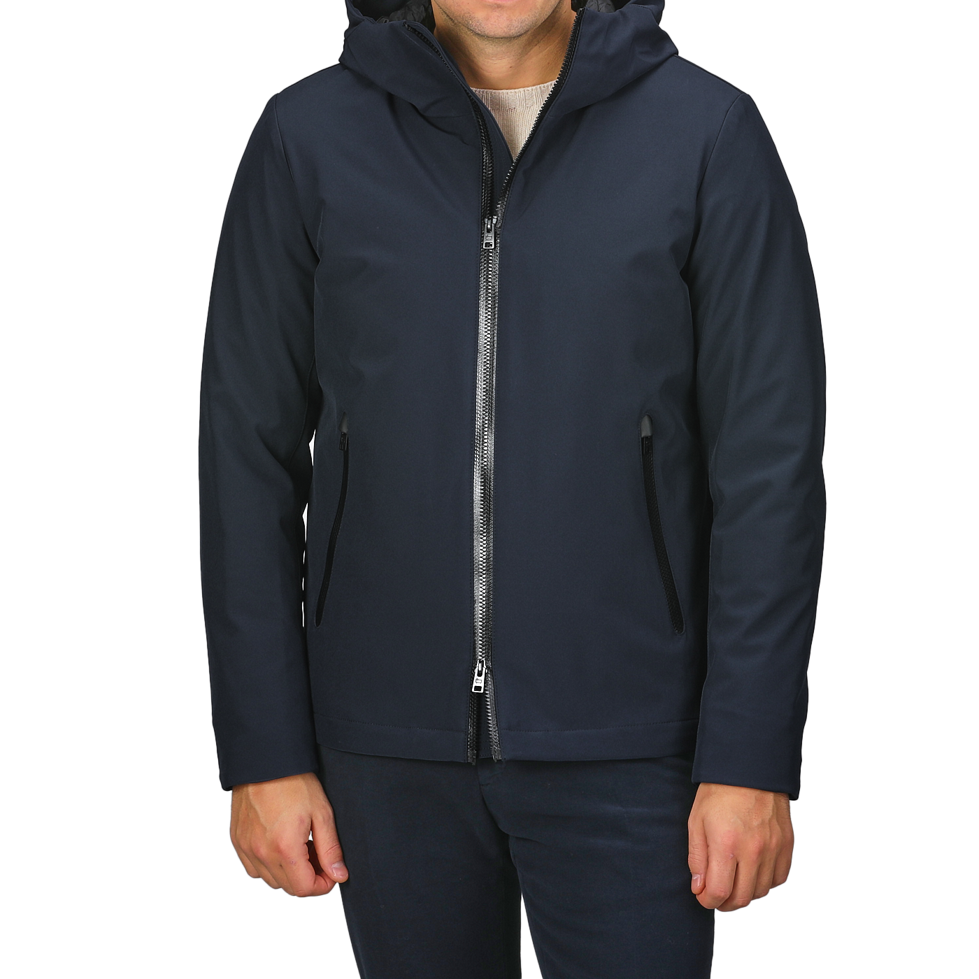 A person wearing a Melton Blue Pacific Soft Shell Jacket from Woolrich, featuring a front zipper and pockets, standing against a light gray background.