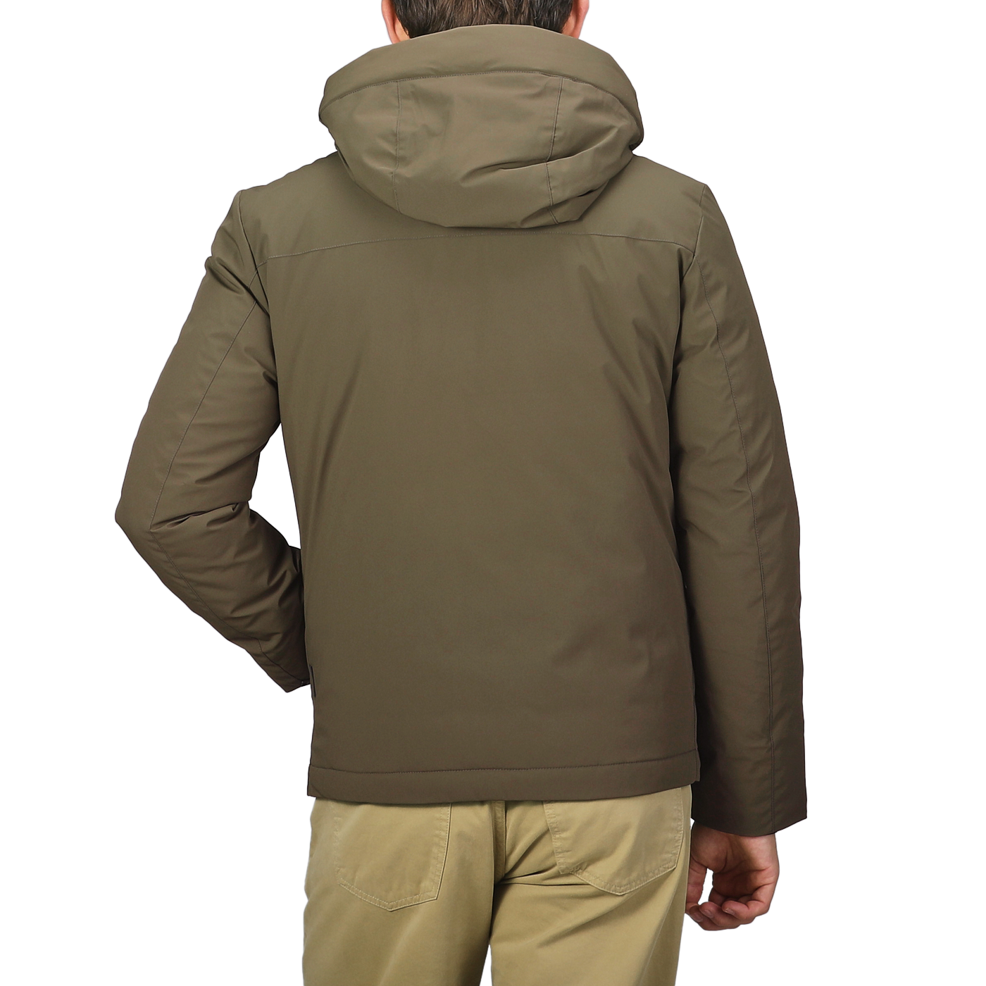 A person wearing a Military Green Stretch Nylon Hood Jacket by Woolrich and beige pants is standing with their back to the camera.