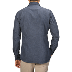 A man wearing a Xacus Blue Melange Cotton Flannel Tailor Fit Shirt and beige pants is seen from the back.