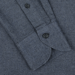 Close-up of a blue melange cotton flannel shirt sleeve from Xacus, featuring two black buttons on the cuff and showcasing a texture similar to pure cotton flannel.