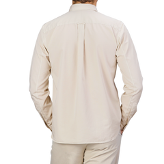 Rear view of a person wearing the Cream Beige Cotton Twill Legacy Shirt by Xacus paired with matching beige pants against a neutral background.