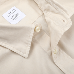 A close-up of the Cream Beige Cotton Twill Legacy Shirt from Xacus, crafted from pure cotton, with a visible label on the collar.