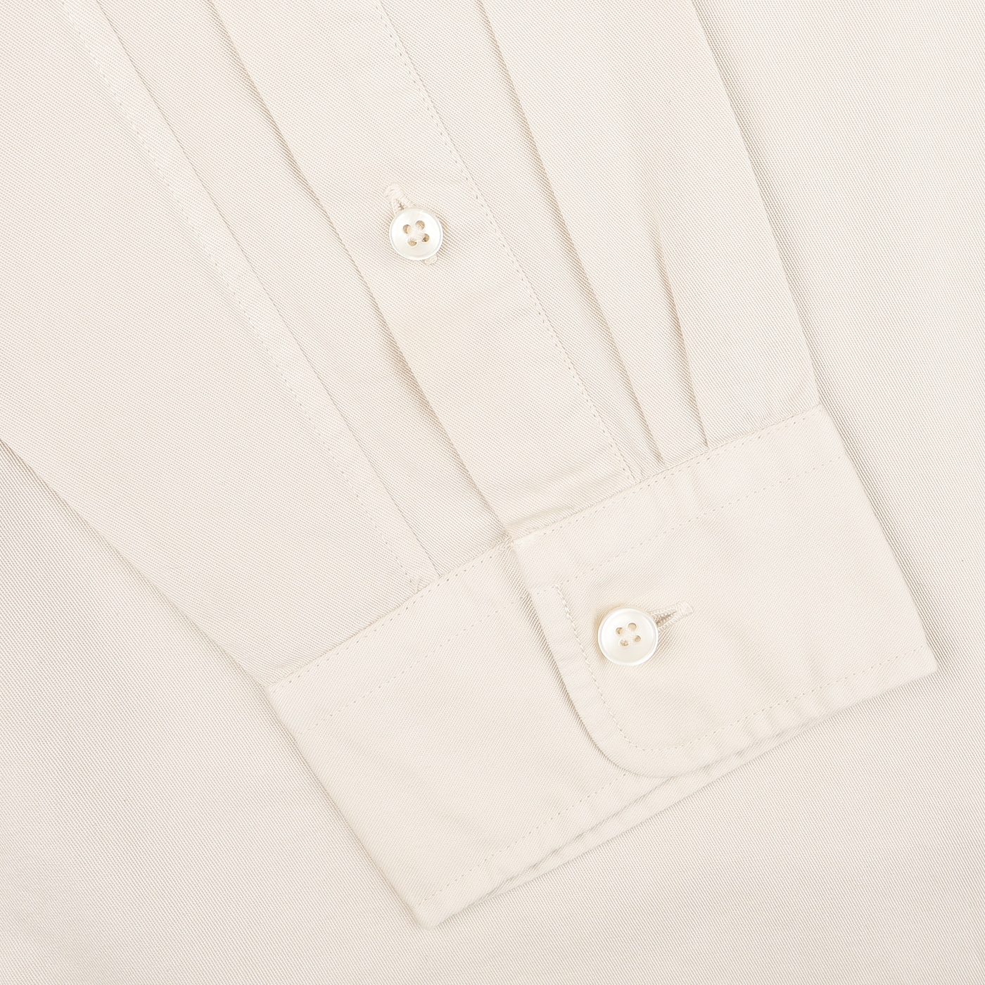 Close-up of the Cream Beige Cotton Twill Legacy Shirt by Xacus, a long-sleeve shirt in a regular fit, featuring two white buttons on the cuff.