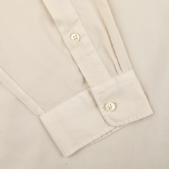 The Xacus Cream Beige Cotton Twill Legacy Shirt displays a cream beige shirt sleeve with two cuff buttons on a matching background, highlighting its pure cotton fabric and casual charm.