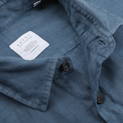 Close-up of the Xacus Dark Blue Washed Linen Legacy Shirt, a regular fit pure linen shirt featuring black buttons and a visible label on the inner collar.