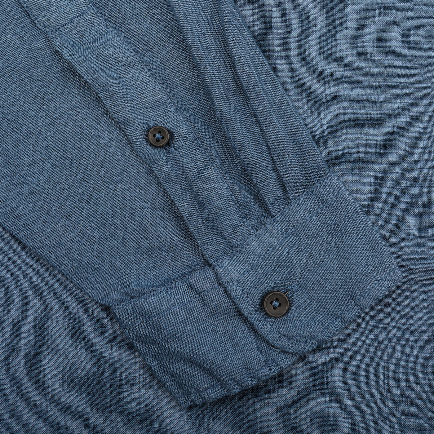 Close-up of the Dark Blue Washed Linen Legacy Shirt by Xacus, highlighting a pure linen sleeve with two sleek buttons.