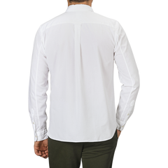 A person wearing a White Cotton Twill Legacy Shirt by Xacus and dark green pants is shown from the back against a plain gray background.