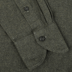 Close-up of the cuff on the Green Melange Cotton Flannel Tailor Fit Shirt from Xacus, featuring a buttoned closure. The button on the placket is clearly visible, highlighting the textured appearance of the pure cotton flannel fabric.