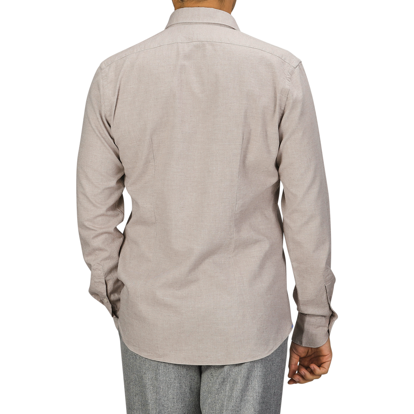 A person wearing a long-sleeved, light beige cotton flannel tailor fit shirt from Xacus and gray pants, photographed from the back against a gray background.