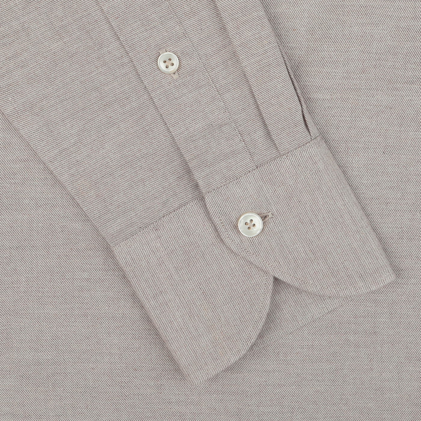 Close-up of the Light Beige Cotton Flannel Tailor Fit Shirt sleeve by Xacus, showcasing two white buttons—one on the cuff and one near the wrist. The pure cotton flannel fabric features a subtle textured pattern.