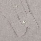 Close-up of the Light Beige Cotton Flannel Tailor Fit Shirt sleeve by Xacus, showcasing two white buttons—one on the cuff and one near the wrist. The pure cotton flannel fabric features a subtle textured pattern.