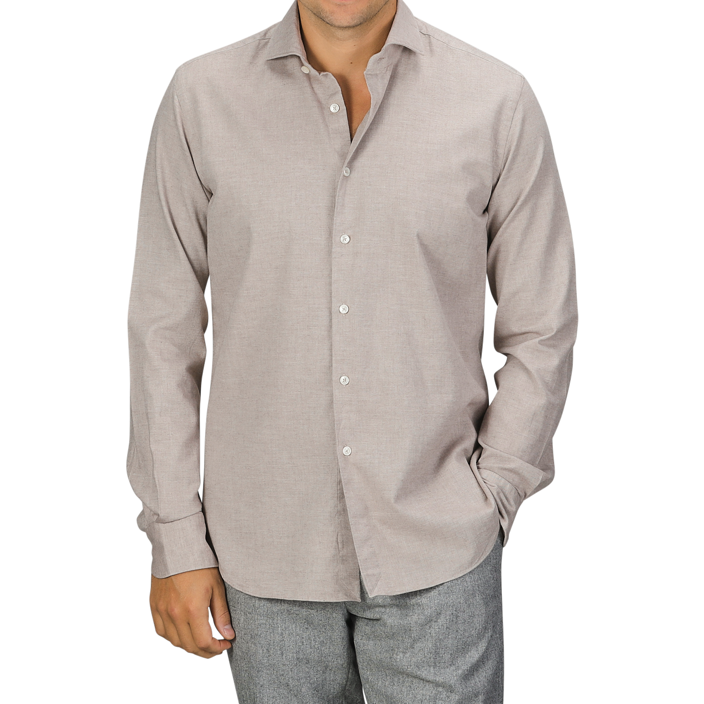 A man in a Light Beige Cotton Flannel Tailor Fit Shirt by Xacus and grey pants stands with one hand in his pocket against a plain background.