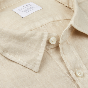 A close up of a Light Beige Washed Linen Legacy Shirt by Xacus.
