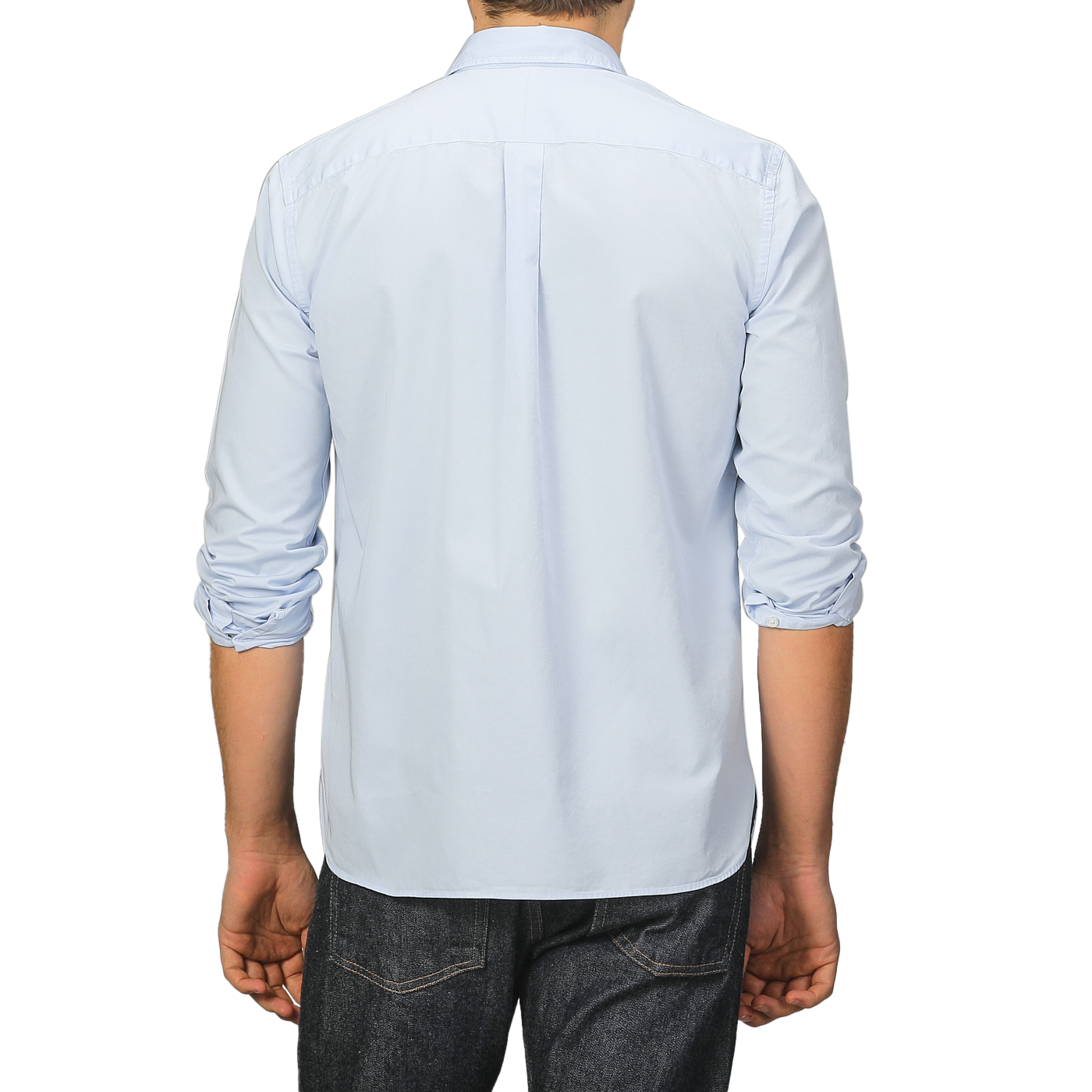 Someone wearing a Light Blue Cotton Twill Legacy Shirt by Xacus and dark jeans is standing with their back to the camera.