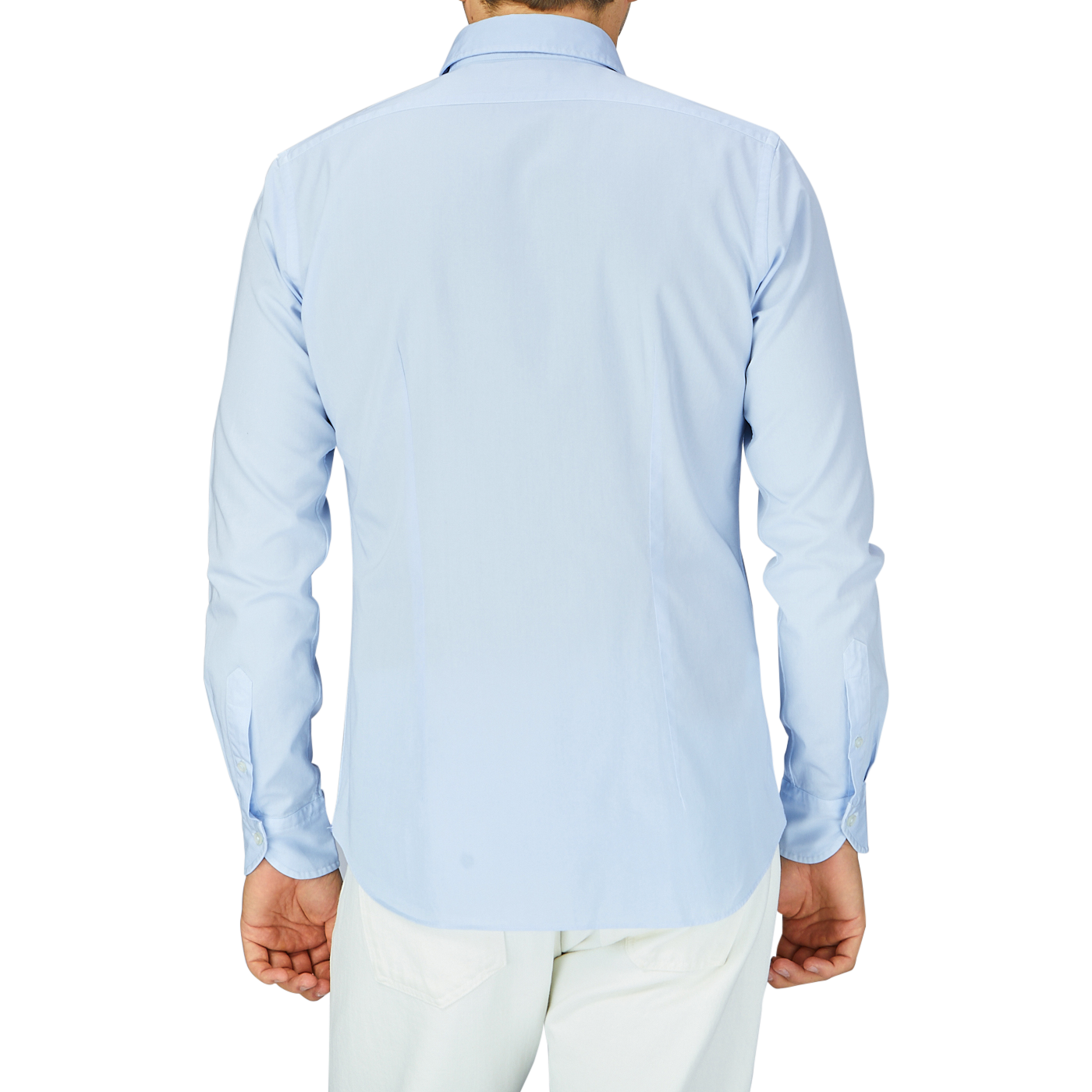 A man standing with his back to the camera, wearing a Xacus Light Blue Cotton Twill Tailor Fit Shirt and white pants.