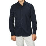 A person wearing a Navy Blue Cotton Corduroy Tailor Fit Shirt by Xacus and white pants against a gray background.