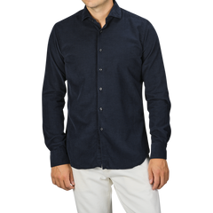 A person wearing a Navy Blue Cotton Corduroy Tailor Fit Shirt by Xacus and white pants against a gray background.