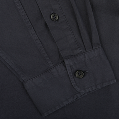 Close-up of a navy blue button-up casual shirt from Xacus, showcasing the cuff and sleeve with buttons, meticulously crafted from pure cotton twill for ultimate comfort.