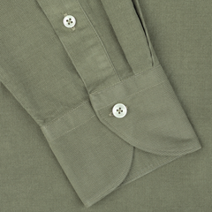 Close-up of an Olive Green Cotton Corduroy Tailor Fit Shirt by Xacus, showcasing the long-sleeve cuff with two white buttons on its textured pure cotton corduroy fabric.