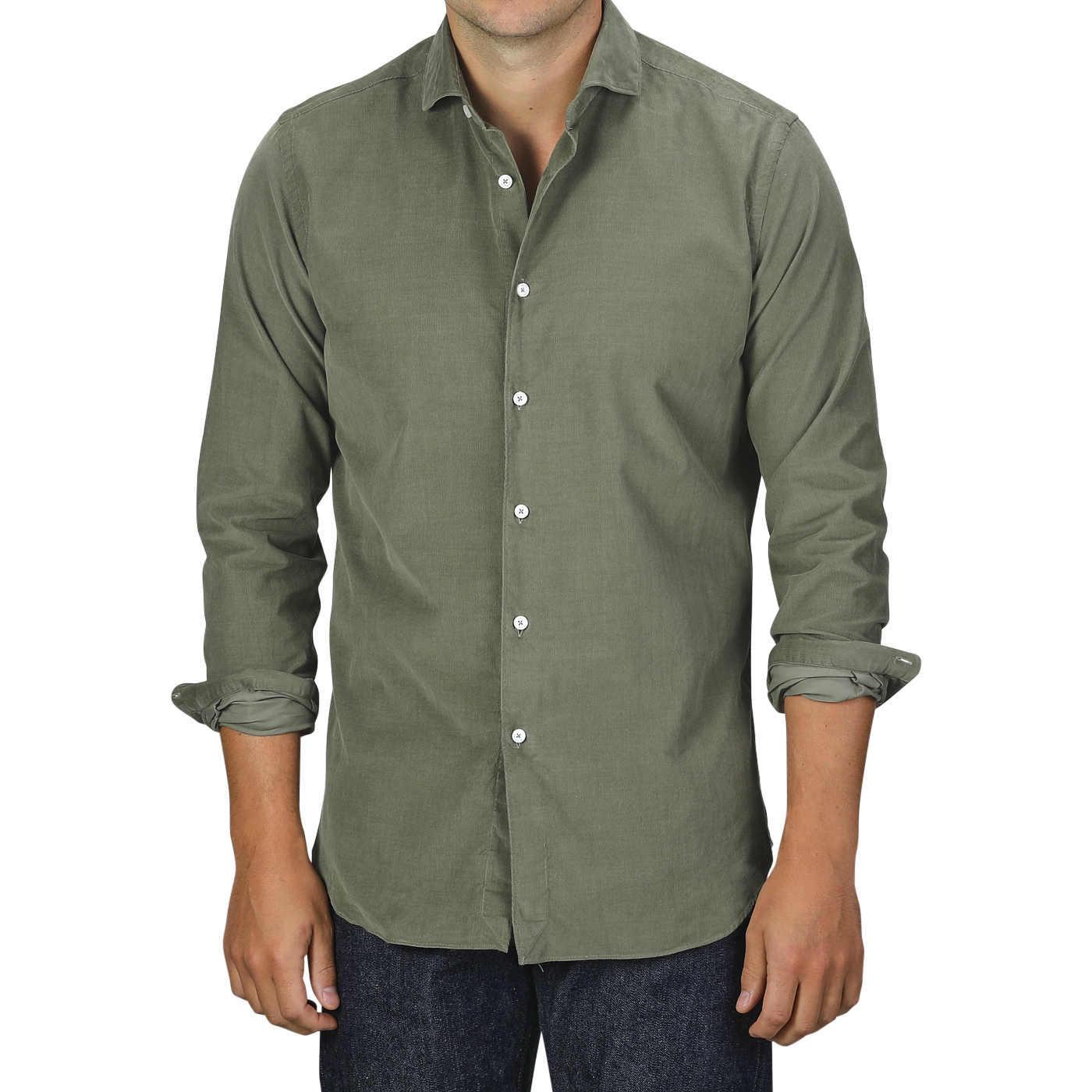 A person wearing an Olive Green Cotton Corduroy Tailor Fit Shirt by Xacus with rolled-up sleeves and dark jeans stands against a plain background.