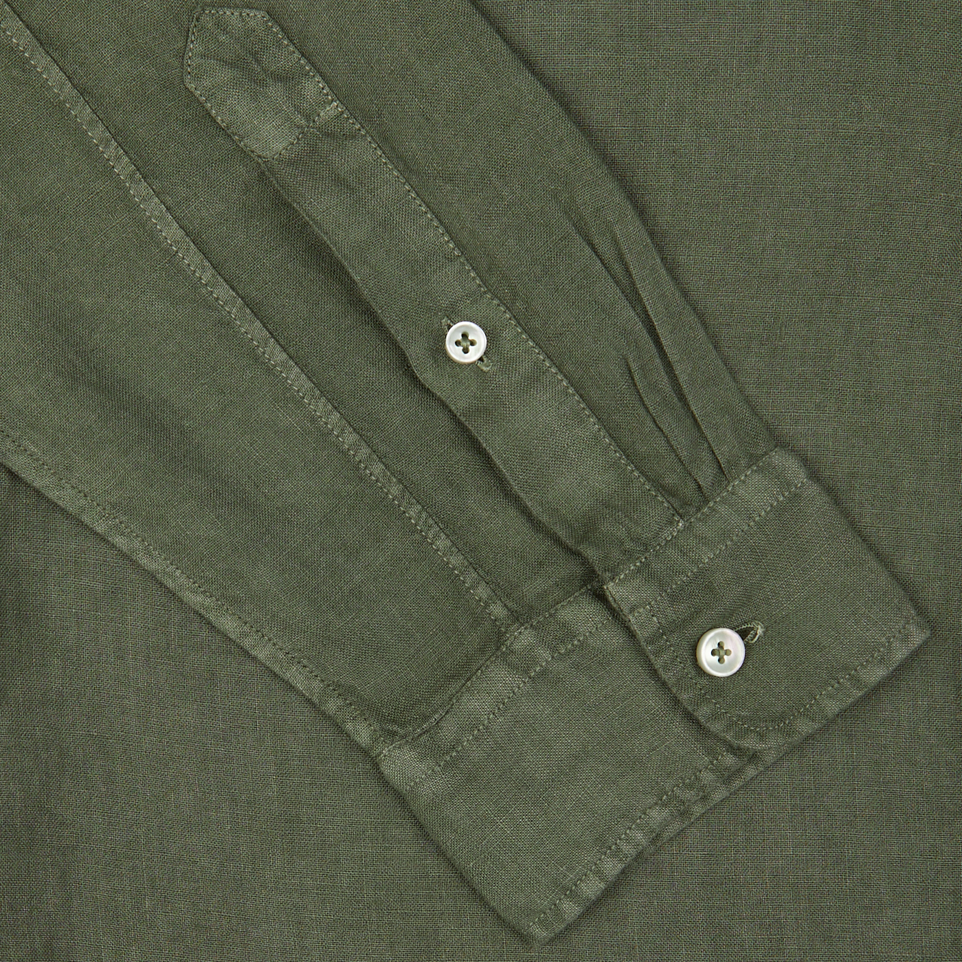 Close-up of an Olive Green Washed Linen Legacy Shirt sleeve with buttons by Xacus.