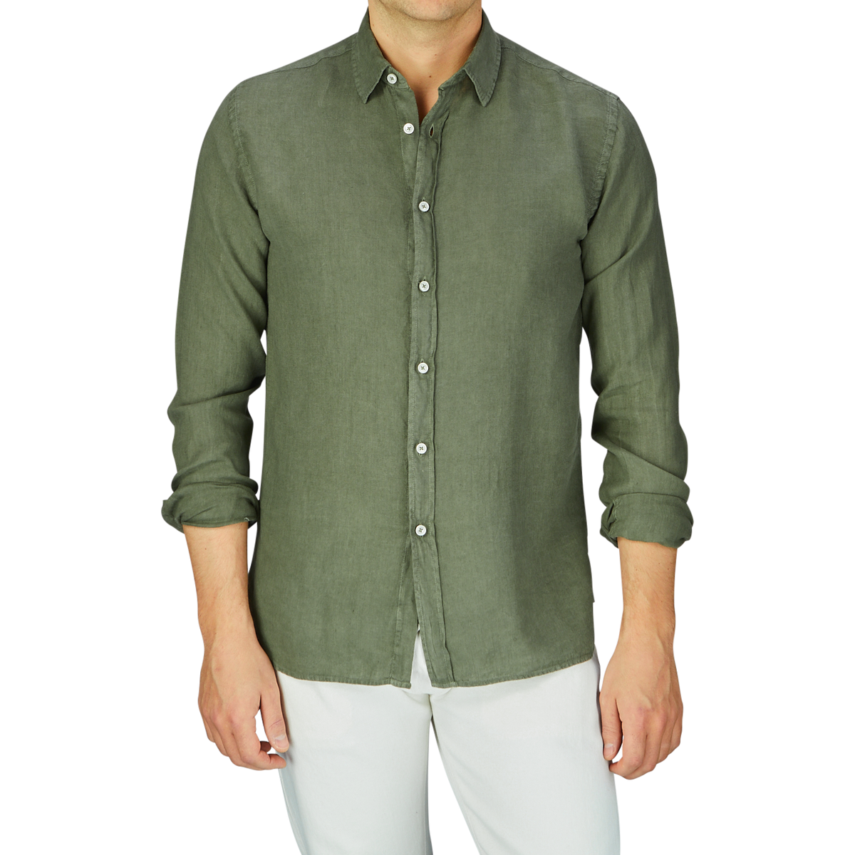 Man wearing an Xacus Olive Green Washed Linen Legacy Shirt with a cut-away collar and white pants.
