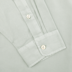 The Xacus Sage Green Cotton Twill Legacy Shirt features a close-up of the cuff with white buttons and meticulous stitched detail, crafted from pure cotton.