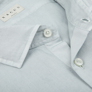 Close-up of a seasonal Xacus Sage Green Cotton Twill Tailor Fit Shirt with a focus on the collar and button.