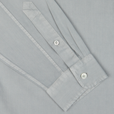Close-up of a Xacus sage green washed cotton twill legacy shirt sleeve with buttons on the cuff.