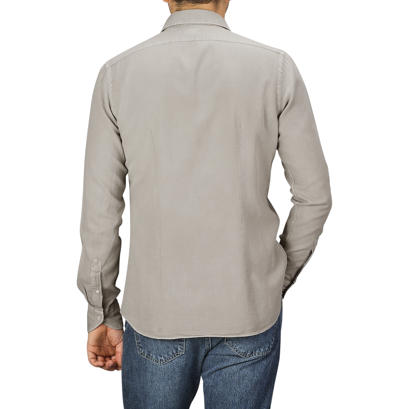 A person is standing with their back to the camera, wearing a Washed Beige Mussola Cotton Tailor Fit Shirt from Xacus and blue jeans.