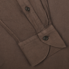 Close-up image of a Washed Brown Mussola Cotton Tailor Fit Shirt by Xacus, highlighting the slim fit sleeves with buttoned cuff and part of the button placket, crafted from pure cotton mussola.