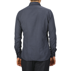 A person wearing a Washed Navy Mussola Cotton Tailor Fit Shirt by Xacus is shown from the back. Only the upper half of the body is visible.