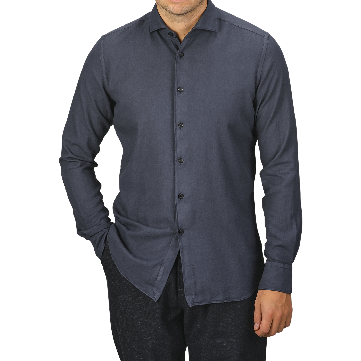 A man is wearing a Washed Navy Mussola Cotton Tailor Fit Shirt from Xacus. The pure cotton material and slim fit accentuate his frame as he stands with one hand in his pocket against a plain background. His face is not visible.